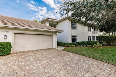 View of front of house with a garage and a front yard