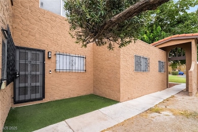 Doorway to property featuring stucco siding