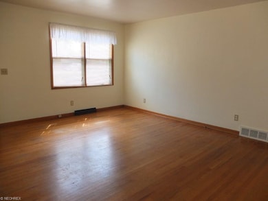 Living room with hardwood flooring.