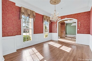 Light filled formal dining room with crown mouldin