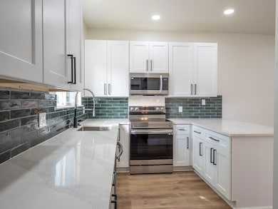 Kitchen featuring stainless steel appliances, whi