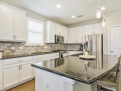 Kitchen with stainless steel appliances, white cab