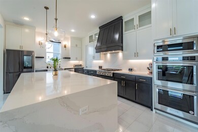 Kitchen with backsplash, premium range hood, stain