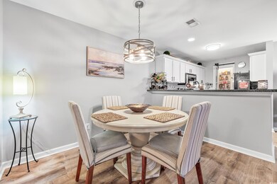 Dining space with light hardwood / wood-style floo