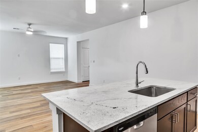 Kitchen featuring a sink, visible vents, dishwashe