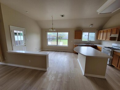 Kitchen with lofted ceiling, white gas range, a c