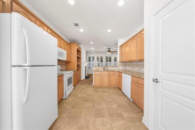 Kitchen featuring white appliances, recessed lighting, ceiling fan, a peninsula, and decorative backsplash