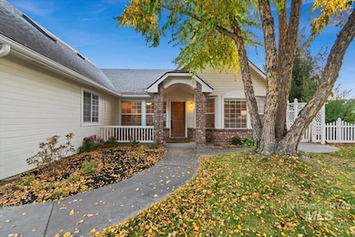 View of exterior entry with brick siding and a shingled roof