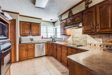 Kitchen featuring sink, crown molding, a textured 