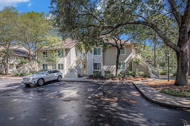 View of front of home featuring stairway and uncovered parking