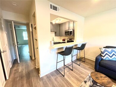 Living looking into counter, kitchen, bedroom