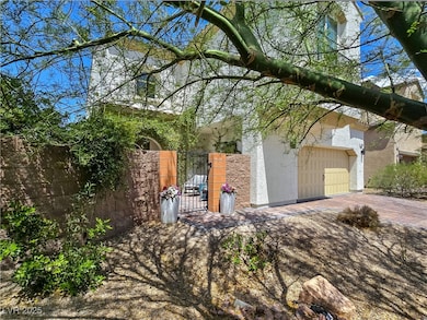 View of side of home with stucco siding, a gate, a