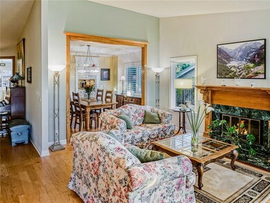 LIVING ROOM FIREPLACE AND VIEW TO DINING ROOM.