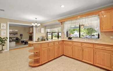 Kitchen with a sink, a chandelier, light countert