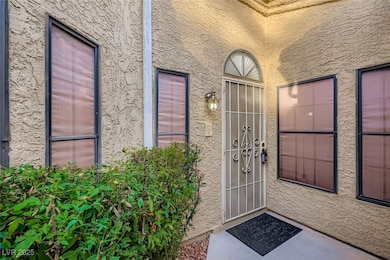 Doorway to property with stucco siding