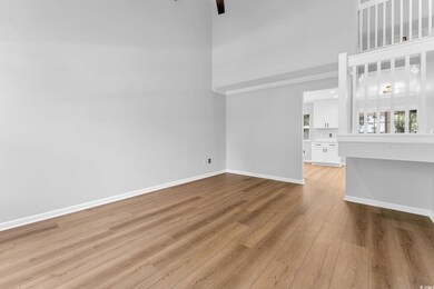Unfurnished living room featuring light hardwood /