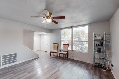 Living area with visible vents, wood finished floo
