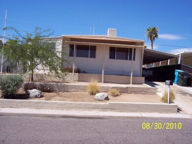 Front straight on, shows carport
