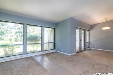 Open concept living enhanced by the wall of windows overlooking the private back yard.