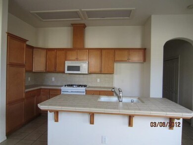 Kitchen with ample storage, and breakfast bar.