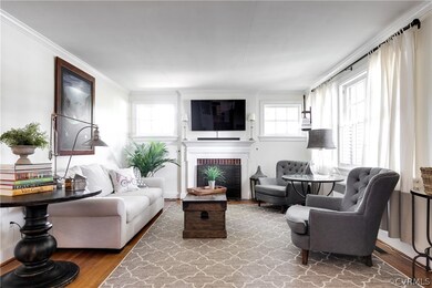 Gorgeous, bright living room.  Stunning hard wood floors throughout the home. Half window plantation shutters add privacy and visual interest.