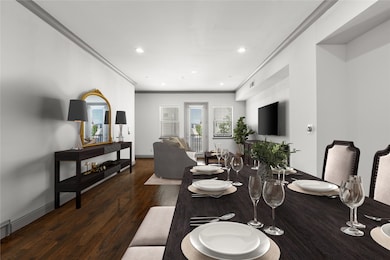 Dining area featuring dark hardwood / wood-style floors and crown molding