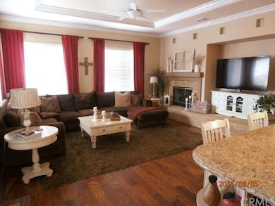 Family room with crown molding and ceiling fan