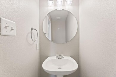 Bathroom with a sink and a textured wall