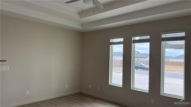 Unfurnished room with ceiling fan and light hardwood / wood-style flooring