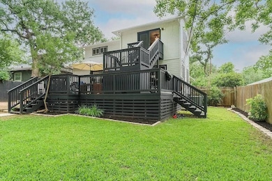 Back of property featuring stairway, a fenced bac