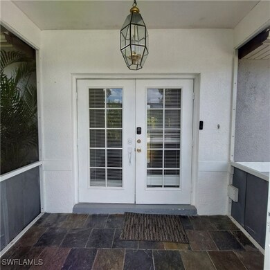 Property entrance featuring french doors and stucc