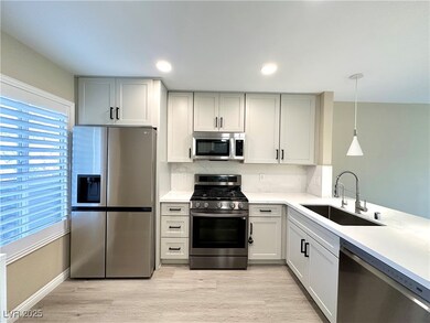 Kitchen with stainless steel appliances, light cou