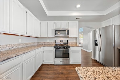 Kitchen with stainless steel appliances, dark wood