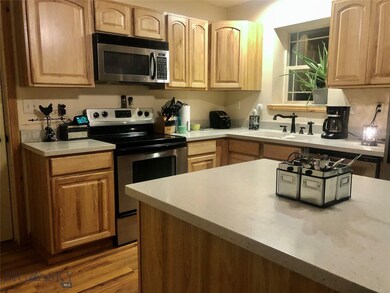 Stainless steel appliances and laminate flooring.