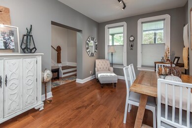 Gorgeous staircase and entry, gleaming hardwood floors, tall base and beautiful window molding!