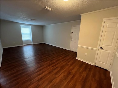 Spare room featuring ornamental molding, a texture