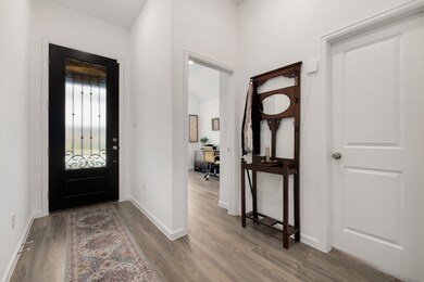 Separated and bright front entry door with hallway to the secondary bedrooms. There is no carpet in this home.