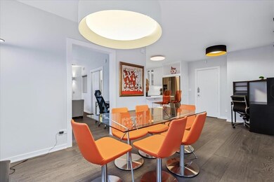 Dining room with dark wood-type flooring, an offi