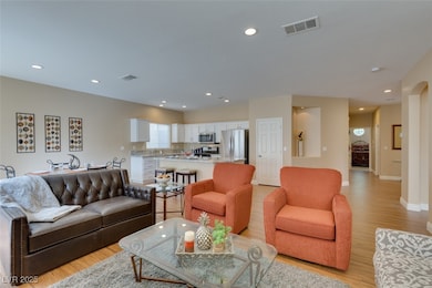 Living area with light wood-style flooring and rec