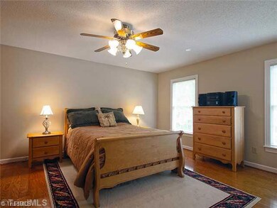 4th Bedroom. The main level bedroom is perfect for overnight guests or could be a master bedroom.  It has lovely wood floors, a private bathroom and a walk in closet.