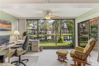 Sunroom / solarium featuring a wealth of natural light, ceiling fan, and a water view