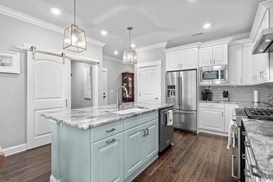 Kitchen featuring sink, high end appliances, white