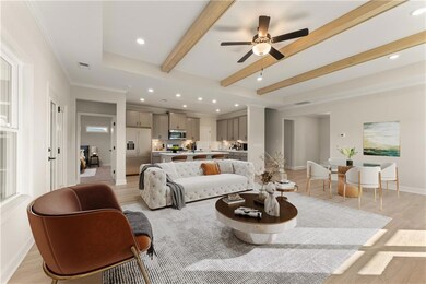 Living room with ceiling fan, crown molding, beame