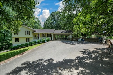 Split level home featuring driveway, a porch, and a carport