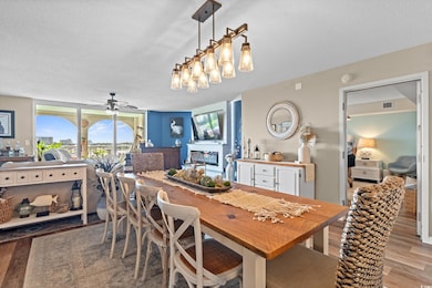 Dining area with wood finished floors, a textured ceiling, and ceiling fan