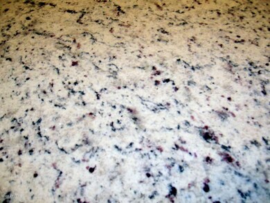 granite slab in kitchen and both baths