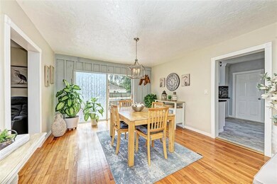 Dining room with kitchen to the left, living room to the right, bedrooms and bathroom straight ahead