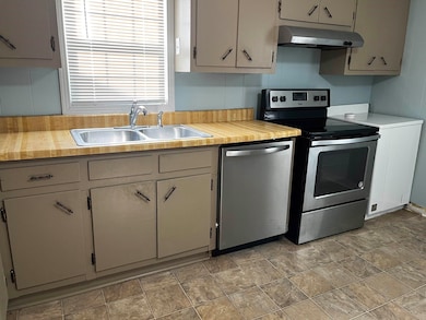Kitchen featuring stainless steel appliances, unde