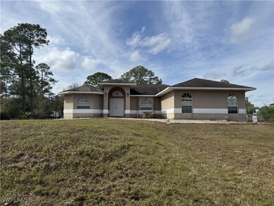 View of front of house with a front lawn and stucc