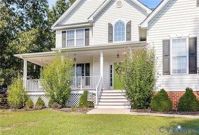 View of front facade with covered porch and a front yard